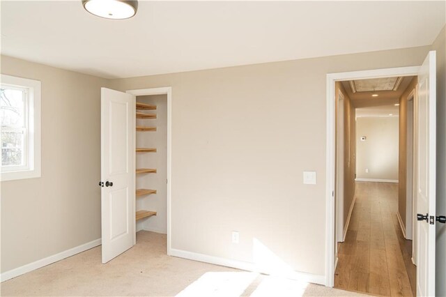 unfurnished bedroom with a closet and light carpet