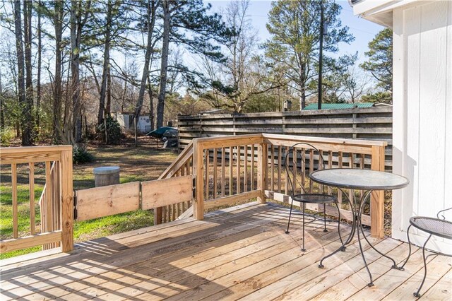 back of property featuring french doors, a deck, and a yard