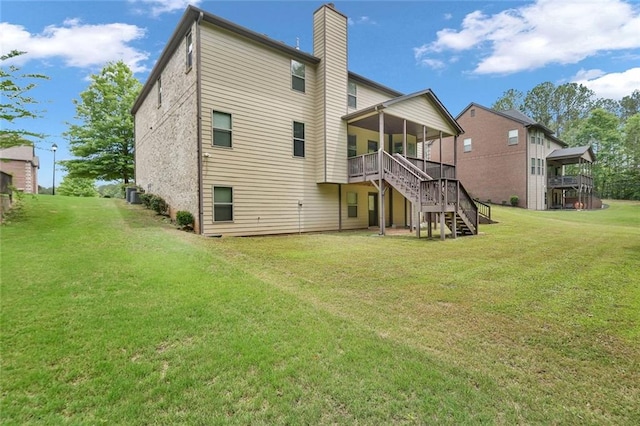 271 Learwood Ln, Atlanta, GA 30349 - back of property with stairway, a chimney, a yard, and a deck