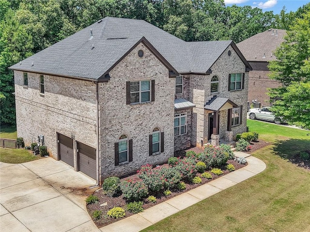 271 Learwood Ln, Atlanta, GA 30349 - view of front of property with an attached garage, a front lawn, concrete driveway, roof with shingles, and brick siding