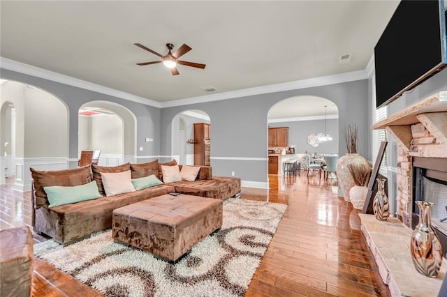 271 Learwood Ln, Atlanta, GA 30349 - living area with ceiling fan, ornamental molding, arched walkways, light wood-style flooring, and a fireplace