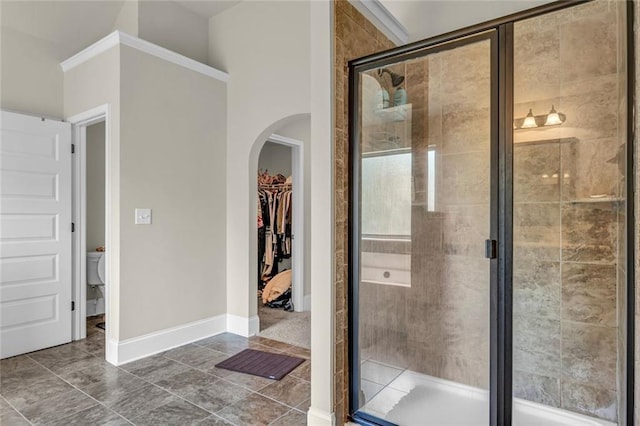 271 Learwood Ln, Atlanta, GA 30349 - bathroom with a shower stall, a spacious closet, baseboards, and toilet