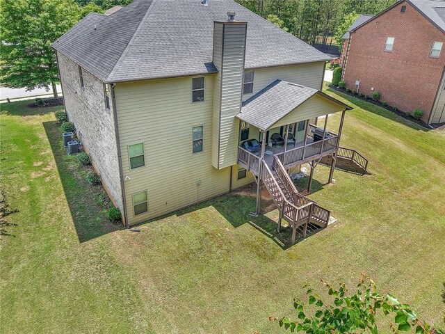 271 Learwood Ln, Atlanta, GA 30349 - back of property with a yard, stairs, roof with shingles, a chimney, and a wooden deck