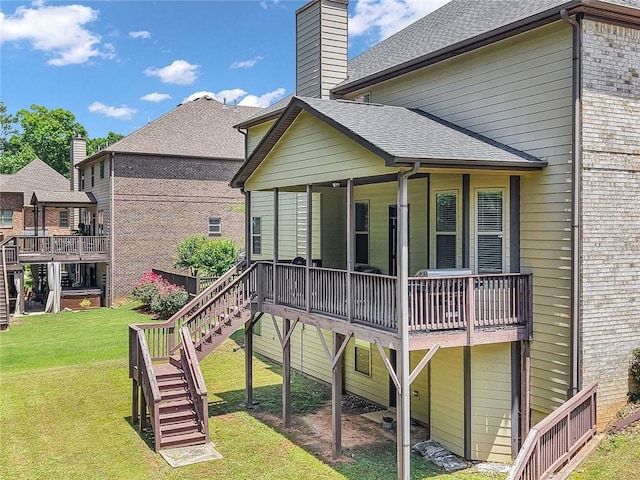 271 Learwood Ln, Atlanta, GA 30349 - rear view of house featuring a lawn, roof with shingles, a chimney, and stairs