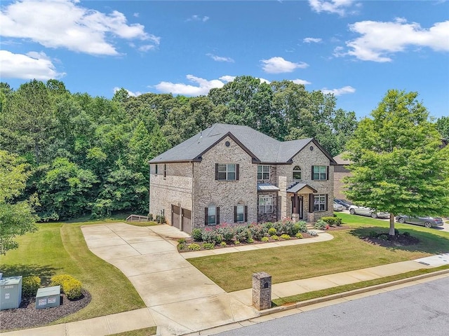 271 Learwood Ln, Atlanta, GA 30349 - view of front of property with a garage, driveway, a front yard, and brick siding