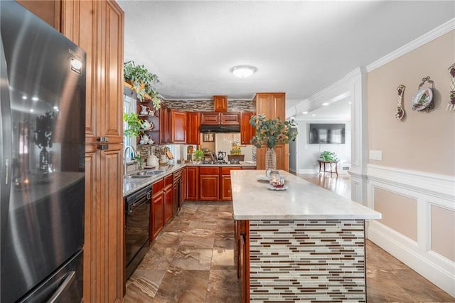 4983 Arcado Rd SW, Lilburn, GA 30047 - kitchen with a wainscoted wall, crown molding, light countertops, a decorative wall, and freestanding refrigerator
