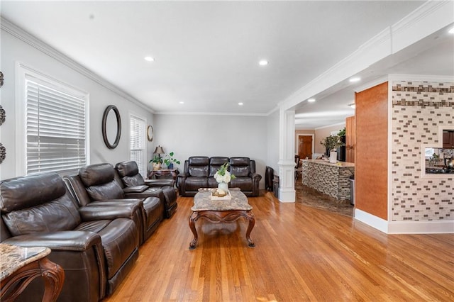 4983 Arcado Rd SW, Lilburn, GA 30047 - living area with ornamental molding, light wood-style flooring, and ornate columns