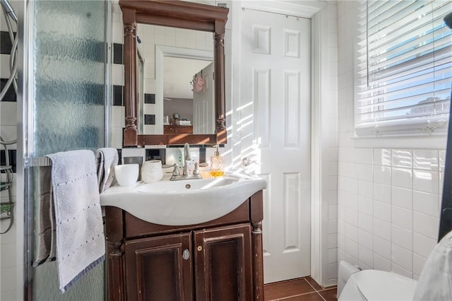 4983 Arcado Rd SW, Lilburn, GA 30047 - bathroom with toilet, tile walls, vanity, and tile patterned floors