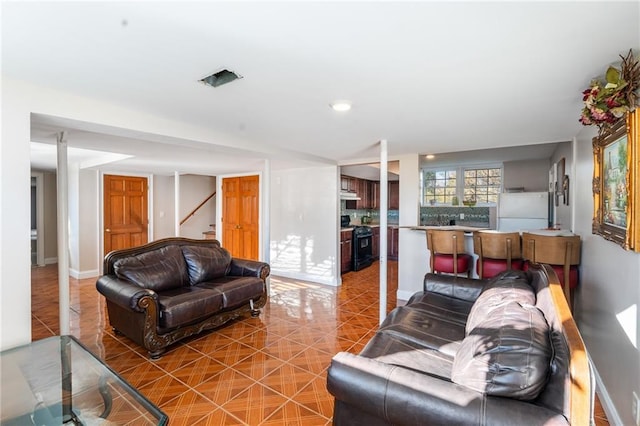 4983 Arcado Rd SW, Lilburn, GA 30047 - living area featuring tile patterned flooring, baseboards, and stairs