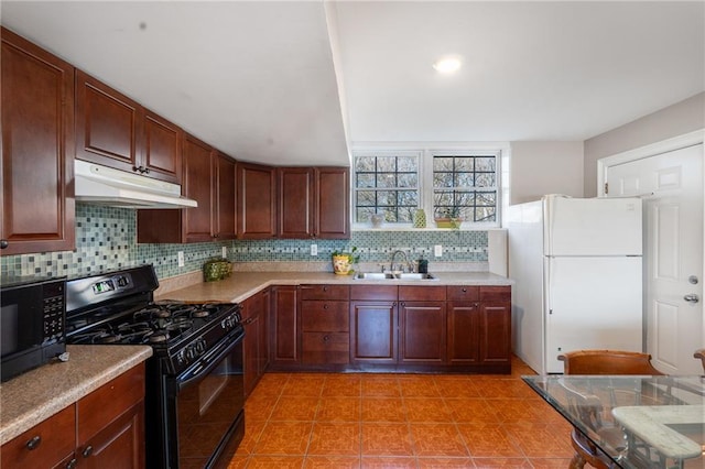 4983 Arcado Rd SW, Lilburn, GA 30047 - kitchen with a sink, under cabinet range hood, light countertops, black appliances, and backsplash