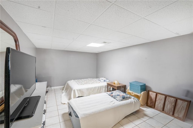4983 Arcado Rd SW, Lilburn, GA 30047 - bedroom with light tile patterned floors, a drop ceiling, and baseboards