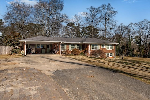 4983 Arcado Rd SW, Lilburn, GA 30047 - single story home with a carport, driveway, brick siding, and fence