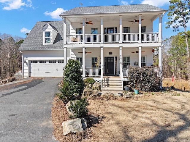 view of front of property featuring aphalt driveway, a porch, a balcony, and a ceiling fan