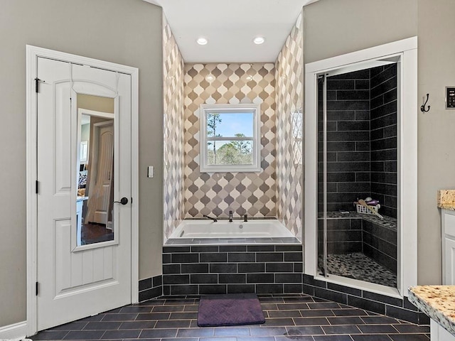 bathroom with recessed lighting, vanity, a tile shower, a bath, and tile patterned floors