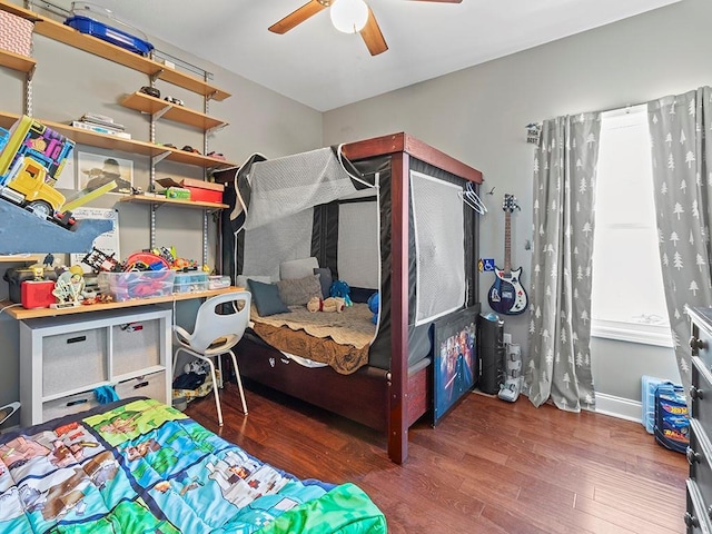 bedroom with ceiling fan, baseboards, and wood finished floors