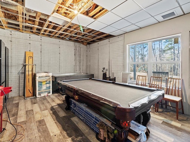 playroom with billiards, brick wall, wood finished floors, and visible vents