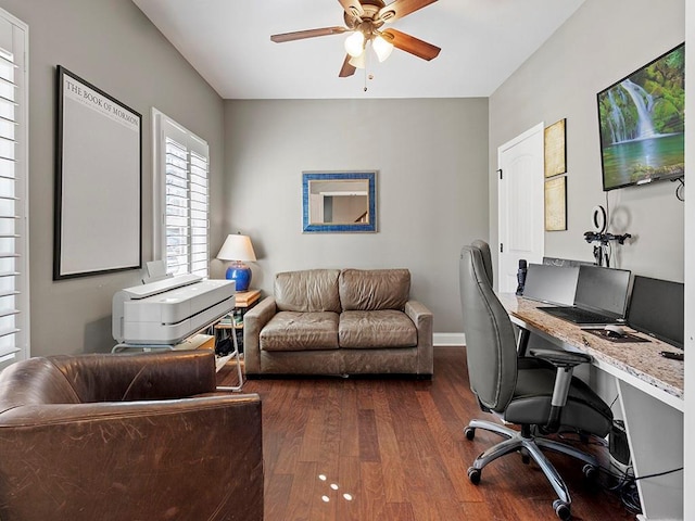 office space with dark wood-style floors, baseboards, and a ceiling fan