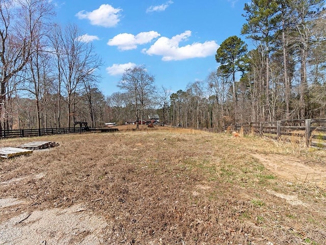 view of yard with fence and a forest view