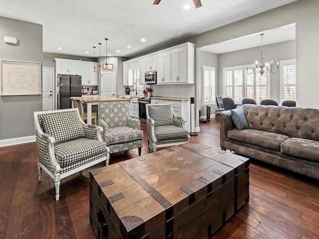 living area featuring dark wood-style floors, recessed lighting, and baseboards