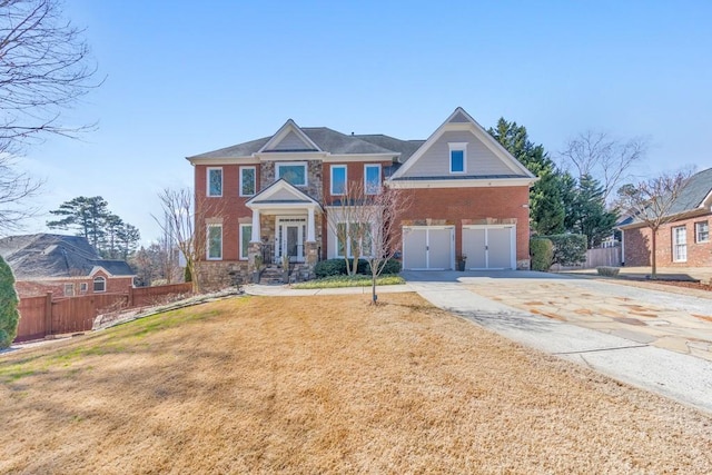 view of front of home featuring driveway, an attached garage, a front lawn, and fence