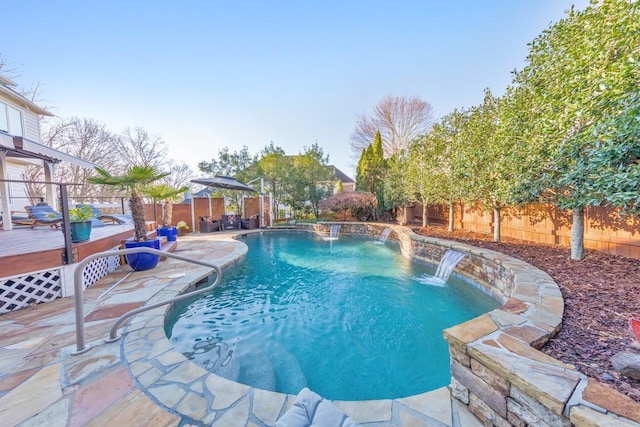 view of pool featuring a deck, a fenced in pool, a patio, and a fenced backyard