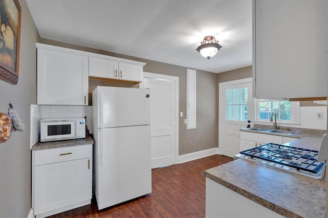 kitchen featuring white appliances, dark hardwood / wood-style floors, sink, and white cabinets