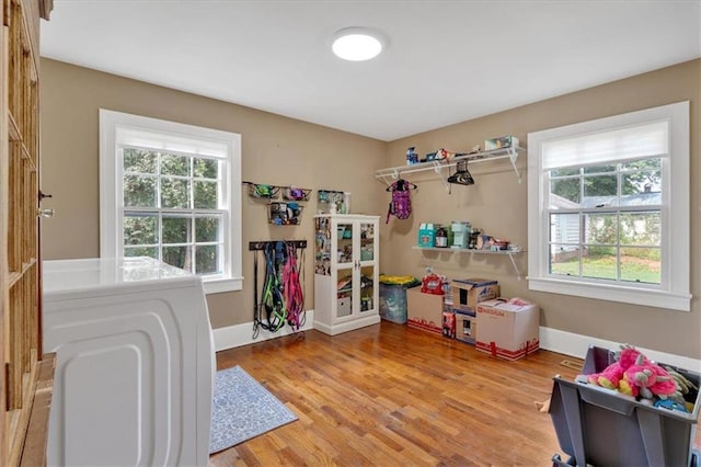 game room with hardwood / wood-style flooring and washer / clothes dryer