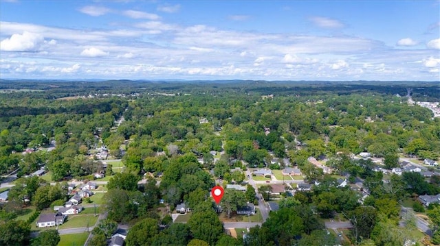 birds eye view of property featuring a view of trees