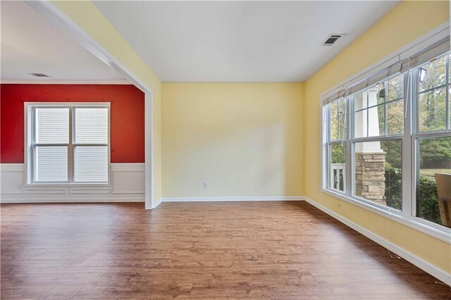 unfurnished room with hardwood / wood-style flooring