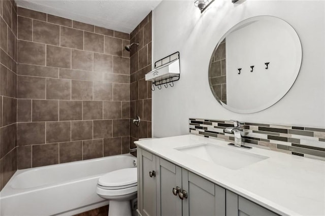 bathroom featuring tasteful backsplash, bathtub / shower combination, vanity, and toilet