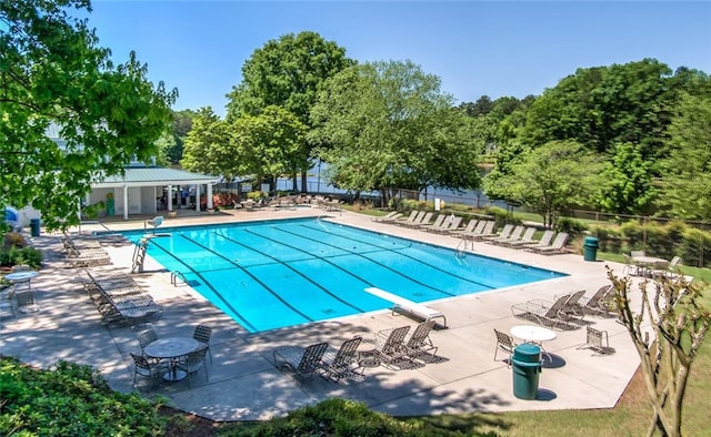 pool with a patio and fence