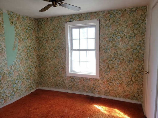 carpeted spare room with ceiling fan, wallpapered walls, and baseboards