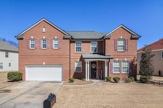 view of front of home featuring brick siding, a garage, and driveway