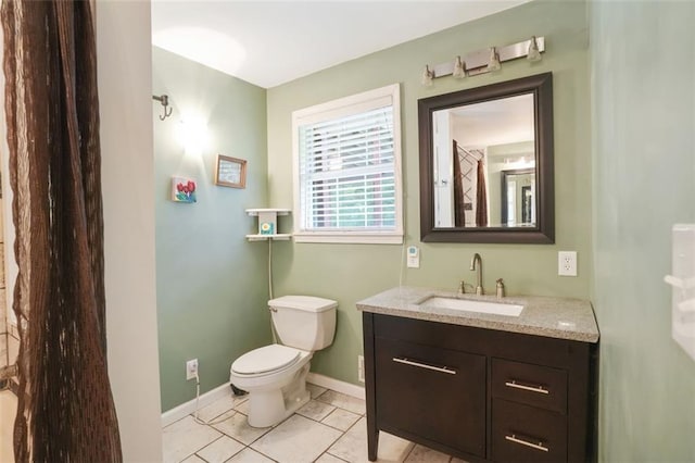 2026 Mcdaniel Mill Rd SW, Conyers, GA 30094 - bathroom featuring vanity, toilet, baseboards, and tile patterned flooring