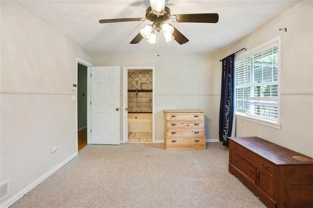 2026 Mcdaniel Mill Rd SW, Conyers, GA 30094 - bedroom with baseboards, light colored carpet, ensuite bath, a ceiling fan, and a textured ceiling