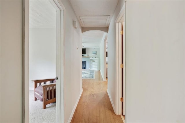2026 Mcdaniel Mill Rd SW, Conyers, GA 30094 - corridor featuring arched walkways, light wood-type flooring, and baseboards