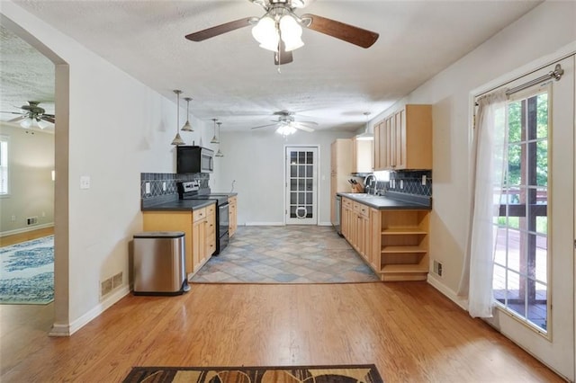 2026 Mcdaniel Mill Rd SW, Conyers, GA 30094 - kitchen with appliances with stainless steel finishes, a ceiling fan, open shelves, tasteful backsplash, and dark countertops
