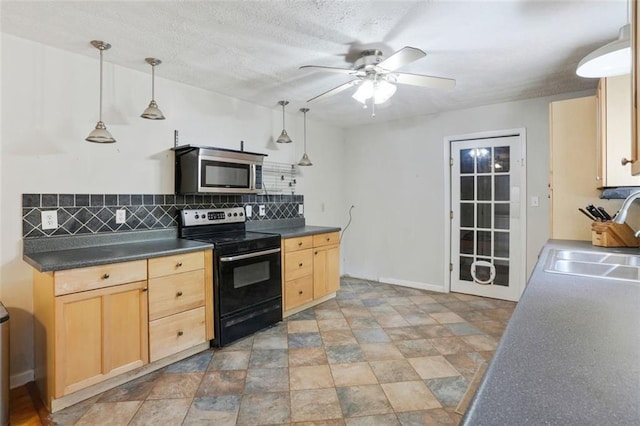 2026 Mcdaniel Mill Rd SW, Conyers, GA 30094 - kitchen with stainless steel microwave, electric stove, a sink, and light brown cabinetry