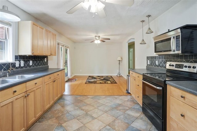2026 Mcdaniel Mill Rd SW, Conyers, GA 30094 - kitchen featuring electric range oven, stainless steel microwave, a ceiling fan, dark countertops, and light brown cabinetry