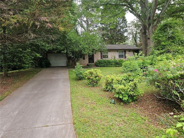 ranch-style house featuring brick siding, a front yard, and concrete driveway