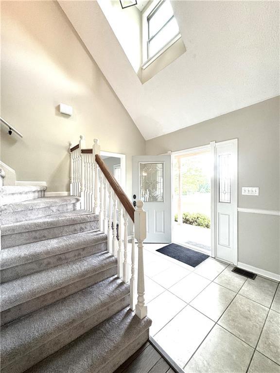 238 Marks Rd, Mansfield, GA 30055 - entryway with stairway, high vaulted ceiling, and tile patterned flooring