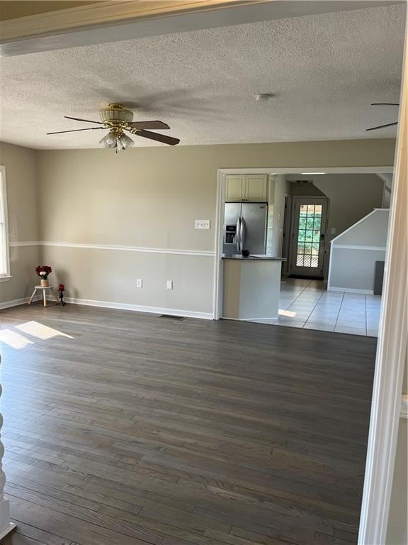 238 Marks Rd, Mansfield, GA 30055 - unfurnished living room with wood finished floors, a ceiling fan, and a textured ceiling