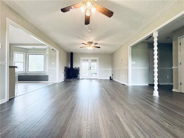 238 Marks Rd, Mansfield, GA 30055 - unfurnished living room featuring a ceiling fan, a textured ceiling, dark wood-style floors, and a wood stove