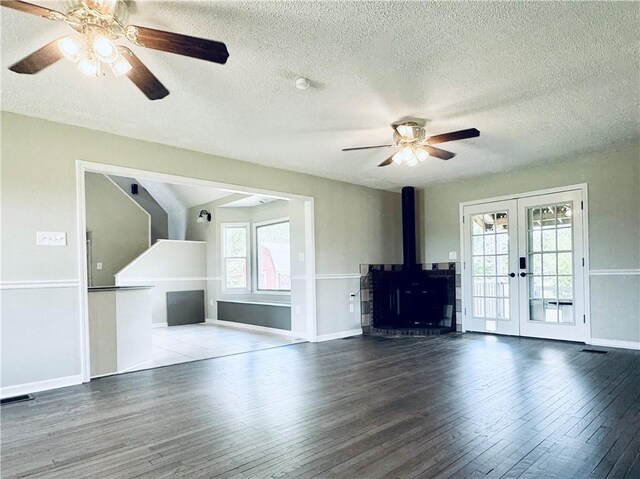 238 Marks Rd, Mansfield, GA 30055 - unfurnished living room featuring french doors, ceiling fan, healthy amount of natural light, wood finished floors, and a textured ceiling