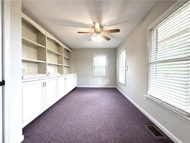 238 Marks Rd, Mansfield, GA 30055 - spare room featuring a textured ceiling, dark carpet, and ceiling fan