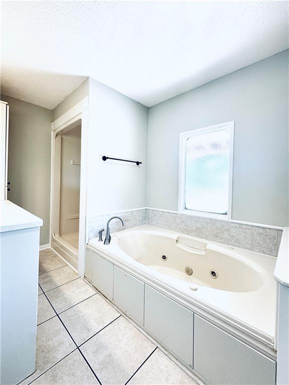 238 Marks Rd, Mansfield, GA 30055 - full bathroom featuring a whirlpool tub, tile patterned flooring, a textured ceiling, and vanity