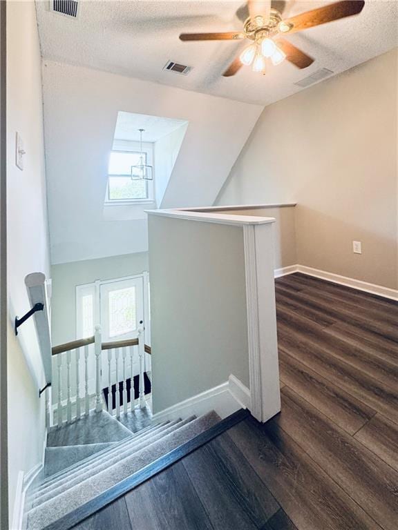 238 Marks Rd, Mansfield, GA 30055 - stairs featuring wood finished floors, a ceiling fan, and a textured ceiling
