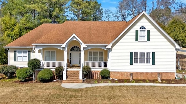 view of front of property with crawl space, a porch, a shingled roof, and a front lawn