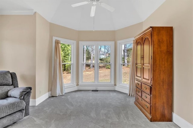 sitting room featuring carpet flooring, a healthy amount of sunlight, baseboards, and vaulted ceiling