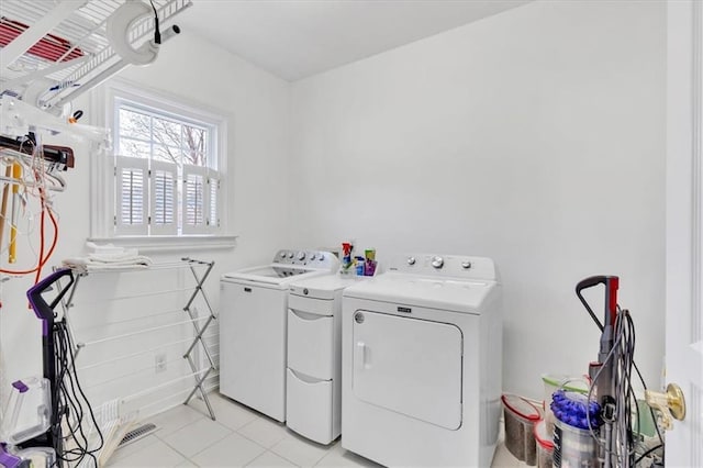 clothes washing area with laundry area, separate washer and dryer, and visible vents